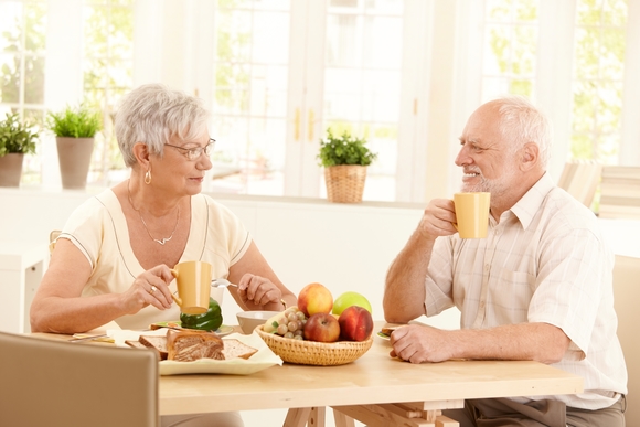 Happy elderly couple having breakfast